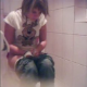 A hidden camera in a bathroom records a young woman farting, peeing, and then trying unsuccessfully to poop.